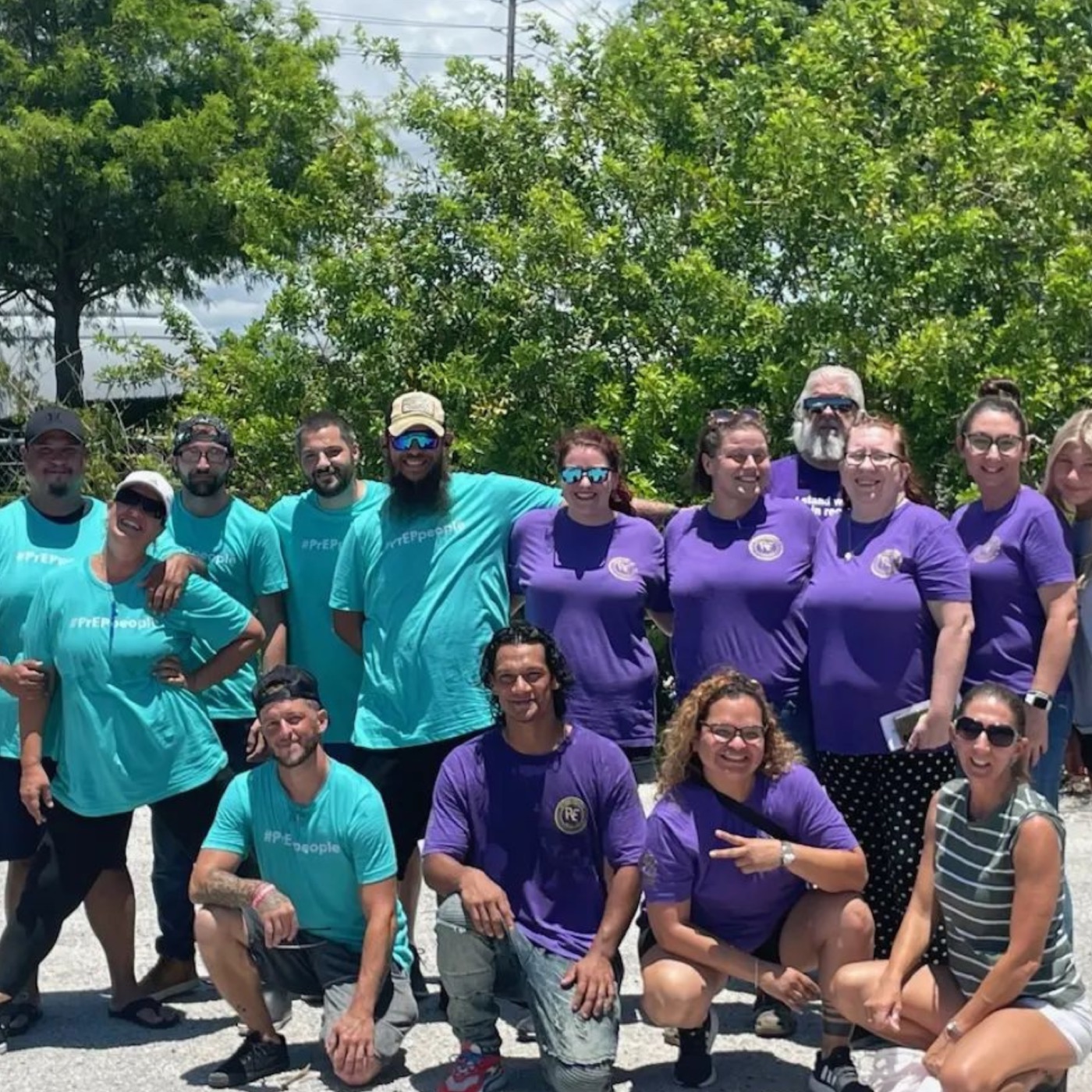 A large group of Recovery Epicenter community members gathered outdoors